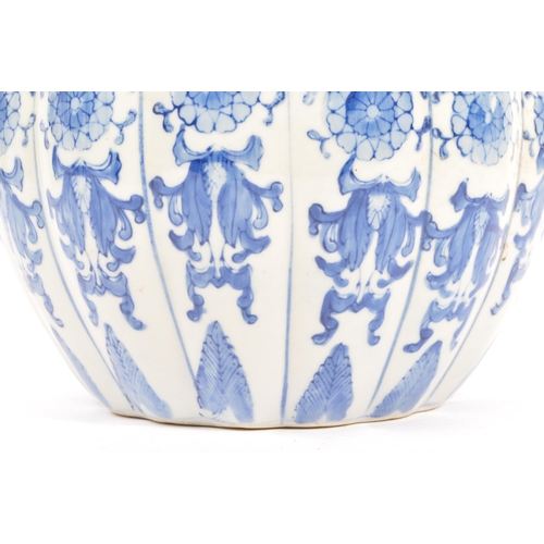 133 - A large blue and white contemporary Chinese pumpkin shaped vase with floral decoration. Measures 21 ... 