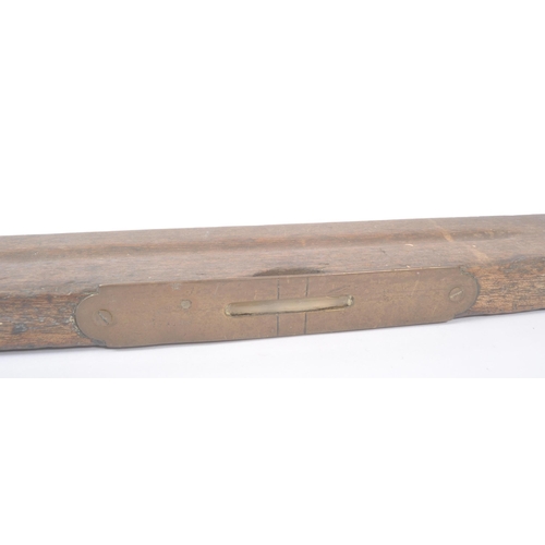 303 - A vintage mid 20th century oak spirit level. Long rectangular form with bubble to centre. Measures a... 