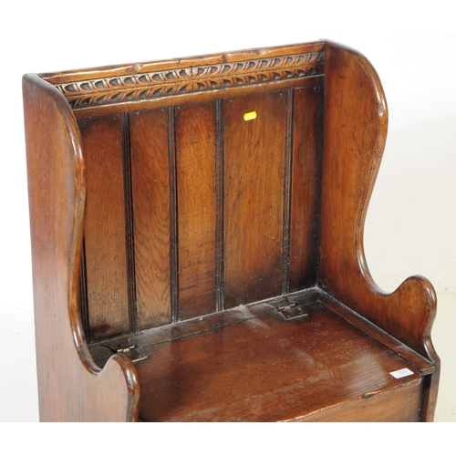 1012 - An early 20th century mahogany ecclesiastic church pew / monks hall bench settle. With pierced back,... 