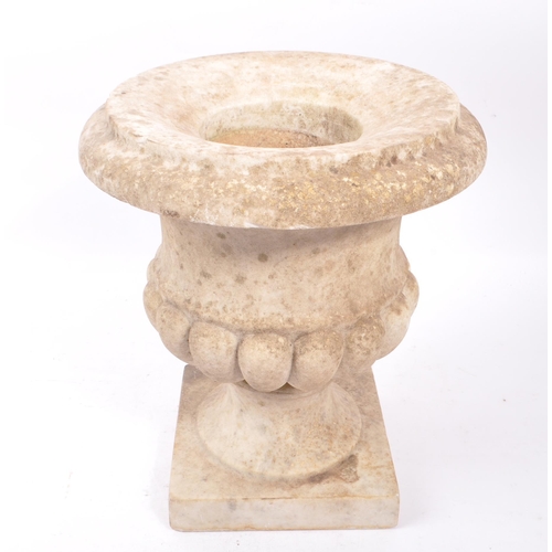 1016 - A composite stone garden planter / campana urn. Having a flared lipped rim, with gadrooned body. Rai... 