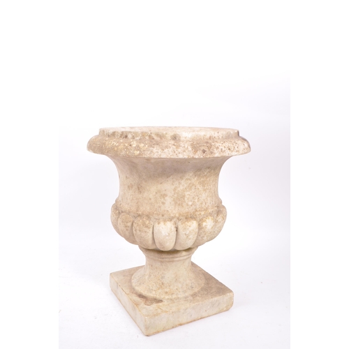 1016 - A composite stone garden planter / campana urn. Having a flared lipped rim, with gadrooned body. Rai... 