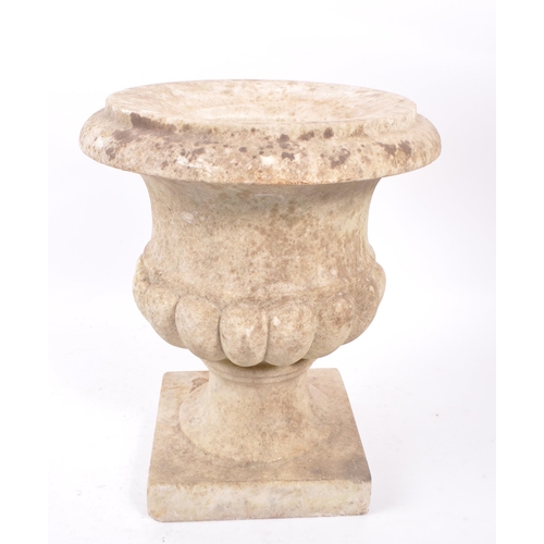 1016 - A composite stone garden planter / campana urn. Having a flared lipped rim, with gadrooned body. Rai... 