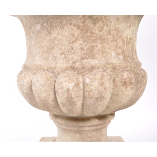 1016 - A composite stone garden planter / campana urn. Having a flared lipped rim, with gadrooned body. Rai... 