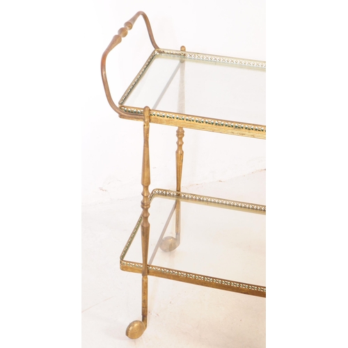 1017 - An early 20th century French brass drinks trolley in the manner of Maison Bagues. The trolley having... 