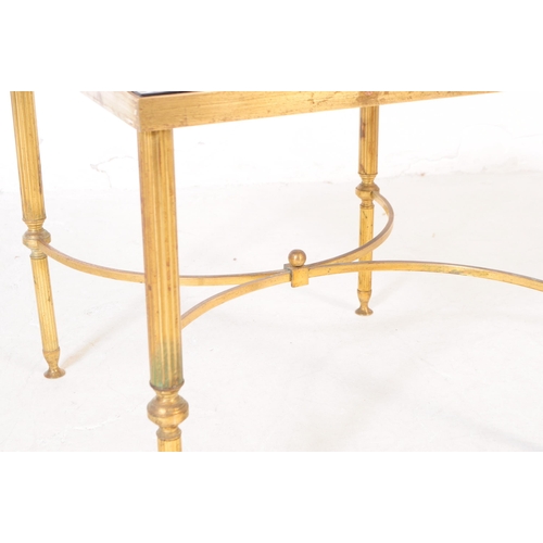 568a - A 20th century Hollywood regency manner brass and smoked glass coffee table. The table of square for... 