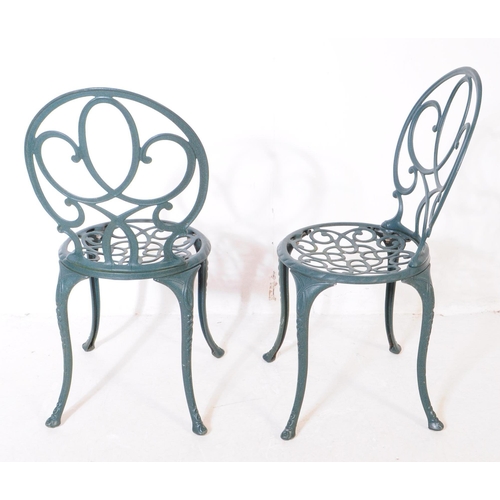 1024 - A Victorian style reproduction garden / courtyard table with a pair of chairs. With pierced oval bac... 