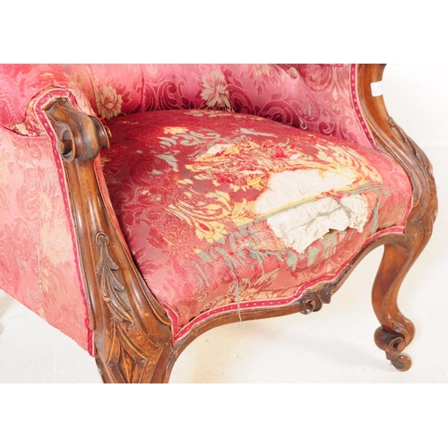 1030 - A Victorian 19th century lounge armchair. Having an arched top with button back rest on padded elbow... 