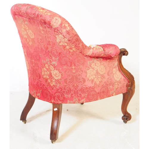 1030 - A Victorian 19th century lounge armchair. Having an arched top with button back rest on padded elbow... 