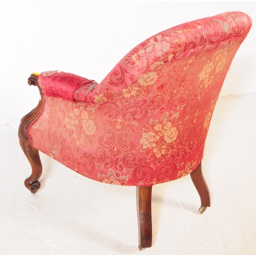 1030 - A Victorian 19th century lounge armchair. Having an arched top with button back rest on padded elbow... 