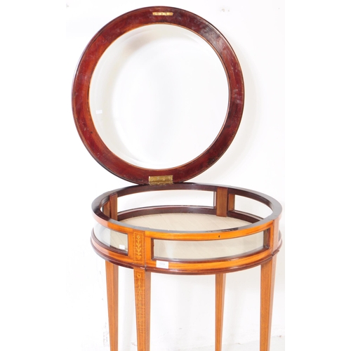 1034 - A 1920s inlaid bijouterie glass display table. Of circular form with glass panel to top, curved glas... 