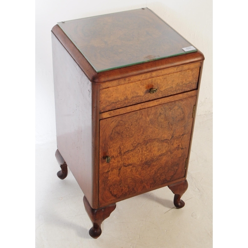 1035 - An early 20th century 1930s Art Deco burr walnut bedside table / cupboard. The bedside raised on cab... 