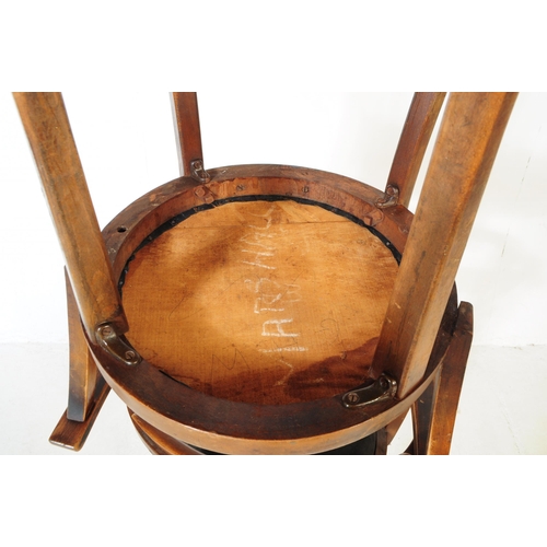 1047 - A set of three mid 20th century bistro Thonet manner bentwood armchairs. Having wrap around tub chai... 