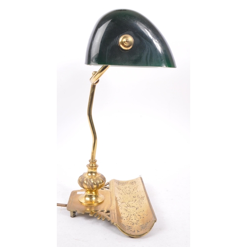 1049 - A vintage 20th Century desktop bankers lamp light having green glass shade upon a metal brass stem s... 