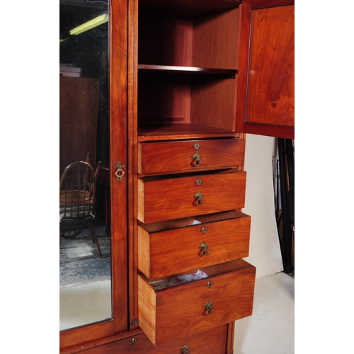 1056 - A 19th century Arts & Crafts mahogany compactum wardrobe. The wardrobe raised on a plinth base below... 