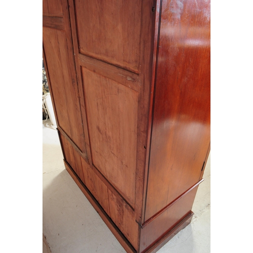 1056 - A 19th century Arts & Crafts mahogany compactum wardrobe. The wardrobe raised on a plinth base below... 