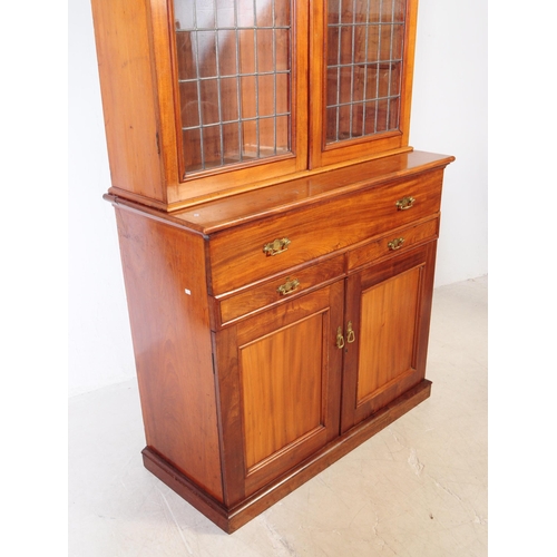 1057 - A large early 20th century mahogany library bookcase cabinet. With pediment top, twin lead glazed hi... 