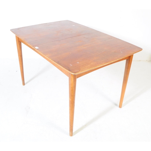 555 - British Modern Design - A mid century teak dining table and four chairs. Rectangular form with exten... 