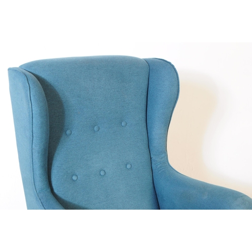 555a - British Modern Design - A contemporary wingback armchair. In a teal colourway with button back desig... 