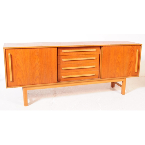 558 - British Modern Design - A mid 20th century circa 1960s teak wood sideboard credenza. The sideboard o... 