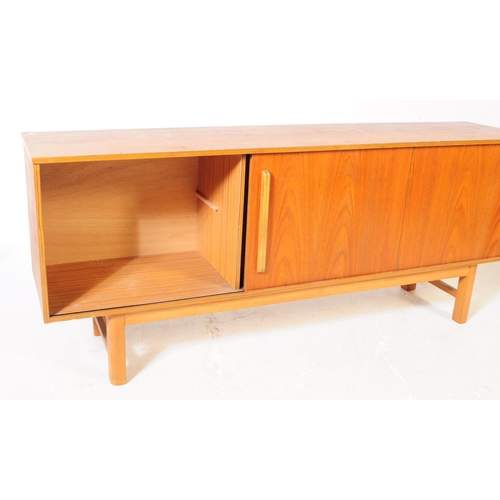 558 - British Modern Design - A mid 20th century circa 1960s teak wood sideboard credenza. The sideboard o... 