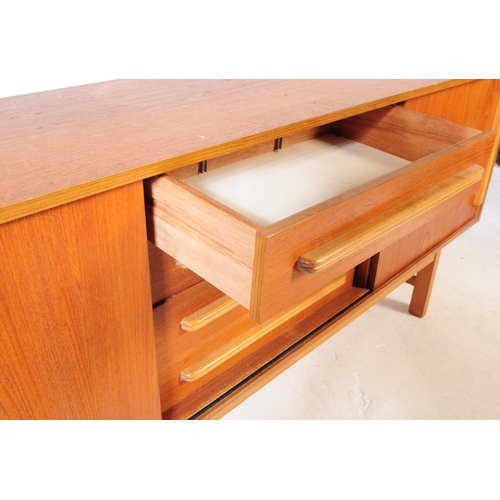 558 - British Modern Design - A mid 20th century circa 1960s teak wood sideboard credenza. The sideboard o... 