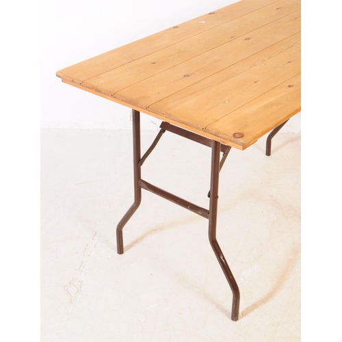 559a - A vintage 20th century pine top bierkeller style trestle table. Rectangular form with plank top on f... 