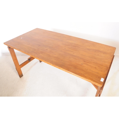 560a - A vintage solid pine wood folding trestle table with cross banded legs. Measures approx. 75cm x 137c... 