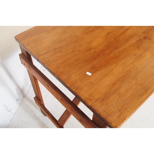 560a - A vintage solid pine wood folding trestle table with cross banded legs. Measures approx. 75cm x 137c... 