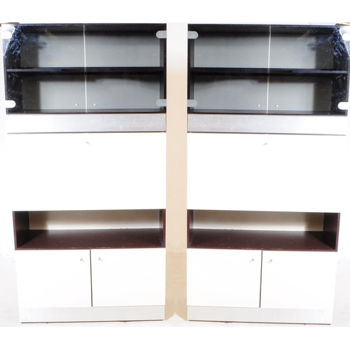 565 - Two contemporary aluminium and glass bookcase / cabinet wall units. Of rectangular form with smoke g... 