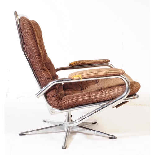 569 - British Modern Design - A retro mid 20th century swivel lounge armchair. Having a brown fabric padde... 