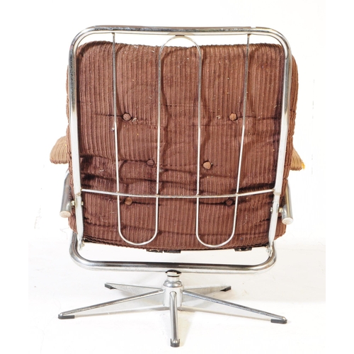 569 - British Modern Design - A retro mid 20th century swivel lounge armchair. Having a brown fabric padde... 