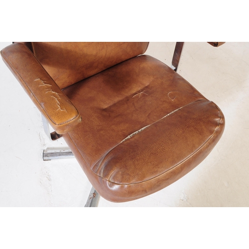 574 - British Modern Design - A mid 20th century tan leatherette and chrome swivel office desk chair. The ... 