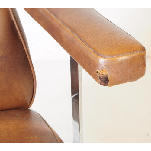 574 - British Modern Design - A mid 20th century tan leatherette and chrome swivel office desk chair. The ... 