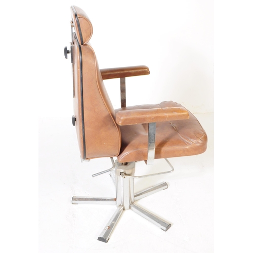 574 - British Modern Design - A mid 20th century tan leatherette and chrome swivel office desk chair. The ... 