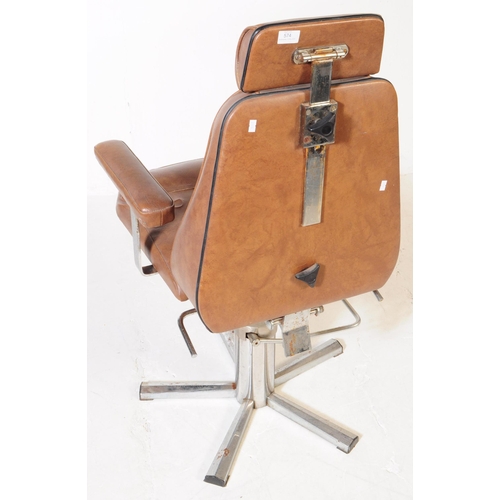 574 - British Modern Design - A mid 20th century tan leatherette and chrome swivel office desk chair. The ... 