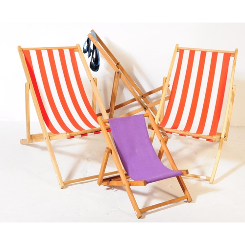 577 - Four contemporary beech wood garden furniture beach deck chairs. The collection to include three lar... 