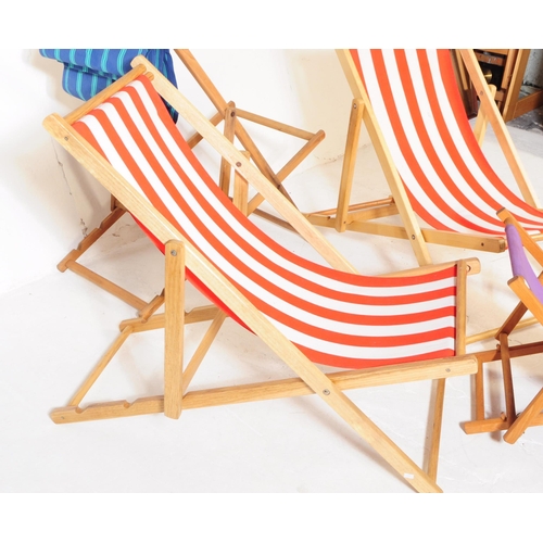 577 - Four contemporary beech wood garden furniture beach deck chairs. The collection to include three lar... 