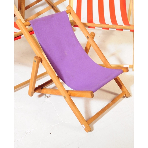 577 - Four contemporary beech wood garden furniture beach deck chairs. The collection to include three lar... 