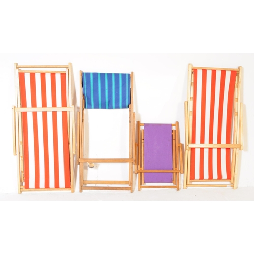 577 - Four contemporary beech wood garden furniture beach deck chairs. The collection to include three lar... 