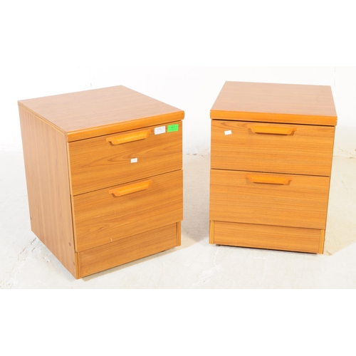 579 - British Modern Design - A pair of retro mid 20th century teak bedside cabinets. Each having a bank o... 