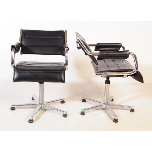 580 - A pair of vintage mid 20th century metal and leatherette chrome office swivel desk chairs. Having a ... 