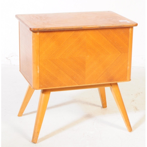 585 - British Modern Design - A mid 20th century oak wood sewing box side table. The sewing box raised on ... 