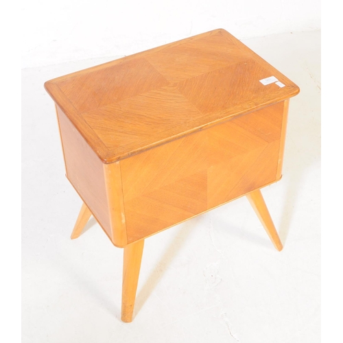 585 - British Modern Design - A mid 20th century oak wood sewing box side table. The sewing box raised on ... 