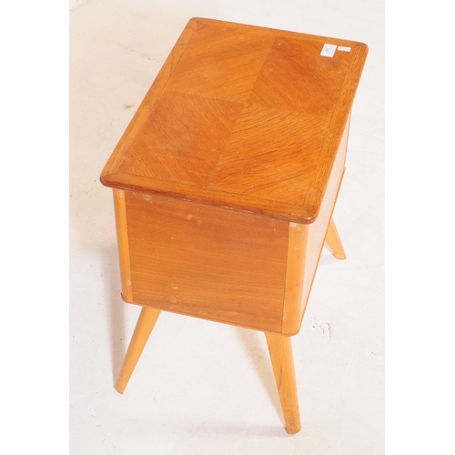 585 - British Modern Design - A mid 20th century oak wood sewing box side table. The sewing box raised on ... 