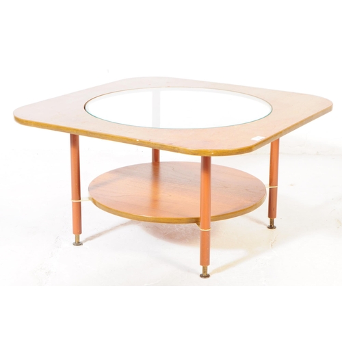 587 - British Modern Design - A mid 20th century formica and teak coffee table. The table featuring a circ... 