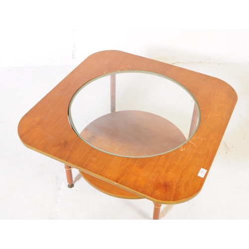 587 - British Modern Design - A mid 20th century formica and teak coffee table. The table featuring a circ... 