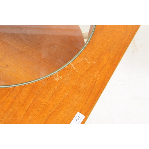 587 - British Modern Design - A mid 20th century formica and teak coffee table. The table featuring a circ... 