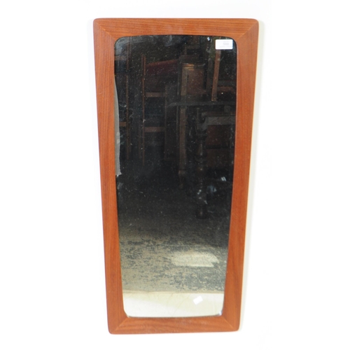 588 - British Modern Design - A mid 20th century teak wall mirror. The mirror having a rectangular frame, ... 