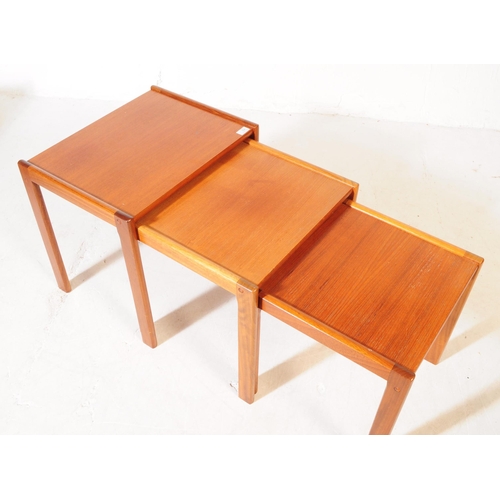 594 - British Modern Design - A mid 20th century teak wood nest of tables. The tables raised on squared le... 