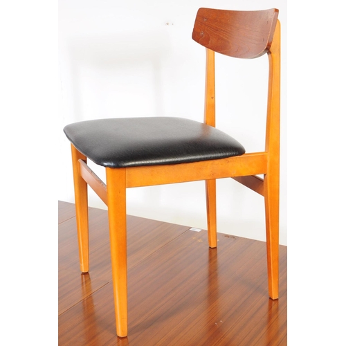 595 - British Modern Design - A retro mid 20th century formica topped dining table and four chairs. The di... 